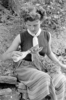 ARH NL Dierssen 1245/0009, Frau säugt das auf ihrem Schoß liegende Rehkitz mit der Flasche, Elze, 1953