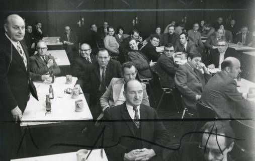 ARH Slg. Bartling 2619, Versammlung von zahlreichen Herren an langen Tischen im Bürgersaal des FZZ sitzend, links am Vorstandstisch stehend und redend Stadtdirektor Otto Hergt, Neustadt a. Rbge., 1973