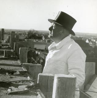ARH Slg. Bartling 2692, Neubau des Kaufhauses Hibbe (?), Marktstraße Nr. 27, Richtfest, Polier mit weißer Maurerjacke und schwarzem Zylinderhut auf dem Gerüst, Neustadt a. Rbge., 1970