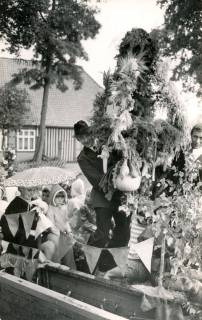 ARH Slg. Bartling 4218, Erntekrone auf einem Anhänger, gehalten von Siegfried Fiene (stehend M.), links daneben sitzend eine Frau mit Kindern beim Erntefestumzug, Hagen, 1973