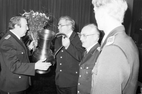 ARH Slg. Weber 02-080/0013, Ortsbrandmeister Willi Siebert erhält eine Vase und einen Blumenstrauß von Werner König, daneben Helmut Schneeberg und Rainer Kunze von der Feuerwehr Gehrden, zwischen 1980/1990