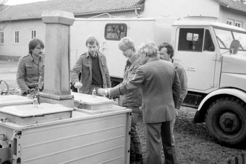 ARH Slg. Weber 02-094/0023, Ortsgruppenleiter der Johanniter-Unfall-Hilfe Hans-Martin Ulrich (rechts) mit weiteren Mitgliedern an einer mobilen Feldküche, Gehrden, zwischen 1980/1990