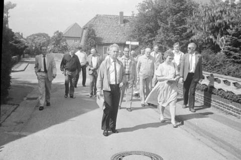 ARH Slg. Weber 02-126/0009, Ortsbürgermeister Waldemar Brandes (vorn mit Aktenmappe) und Stadtdirektor Hans Bildhauer (links) bei einer Ortsbegehung mit dem Ortsrat und Anliegern im Pagenburgweg, Lenthe, zwischen 1980/1990