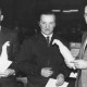 Stadtarchiv Neustadt a. Rbge., ARH Slg. Bartling 565, Kreis-Landvolkvorsitzender Friedrich Rohde, Esperke, überreicht eine Ehrenurkunde samt Flasche an zwei verdiente Landwirte