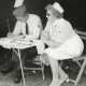 Stadtarchiv Neustadt a. Rbge., ARH Slg. Bartling 2348, Karla Wollner und Karlheinz Harjürgen bei einer Übung im Zelt an einem Campingtisch sitzend und schreibend, DRK-Kreisverband, Neustadt a. Rbge.