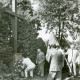 Stadtarchiv Neustadt a. Rbge., ARH Slg. Bartling 3494, Kranzniederlegung am Gedenkkreuz für die Toten im Osten ("Kreuz des Ostens") durch einige Männer mit der Fahne der Landsmannschaft Westpreußen, Kreisverband Neustadt beim Friedhof an der Lindenstraße 44, Neustadt a. Rbge