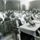 ARH Slg. Bartling 4427, Gut gesuchte Versammlung im Saal des Gasthauses Küster, Blick diagonal über die Kaffeetische, rechts die Bühne mit einer Musikband, links der Auftritt eines Akkordeonspielers, Mandelsloh